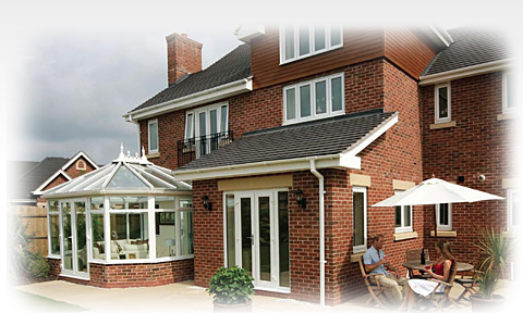 A photo of people relaxing in front of their modern house with new UPVC windows